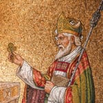 A golden mosaic of St. Patrick holding a clover.