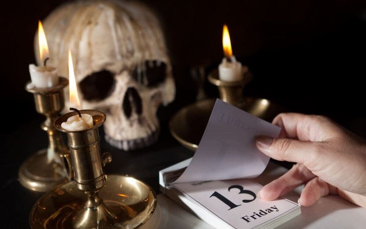 Friday 13th on a calendar with candles and a creepy skull. Myths and Legends, superstition, supernatural