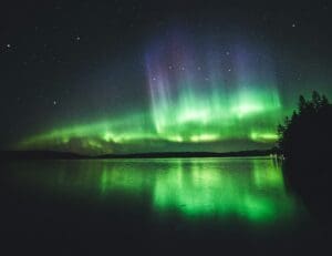 The Aurora Borealis shimmering over Finland. Transformational Travel, Unique Travel Experiences