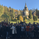 Our travelers in front of the stunning Peles Castle. Transformational Travel, Mysterious Adventures