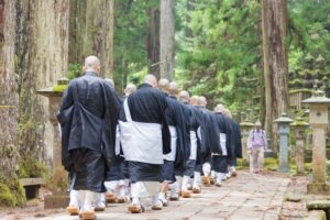 Monks walk through Okunoin Cemetery on Mount Kōya. Spiritual Journey, Mysterious Adventures, Transformational Travel
